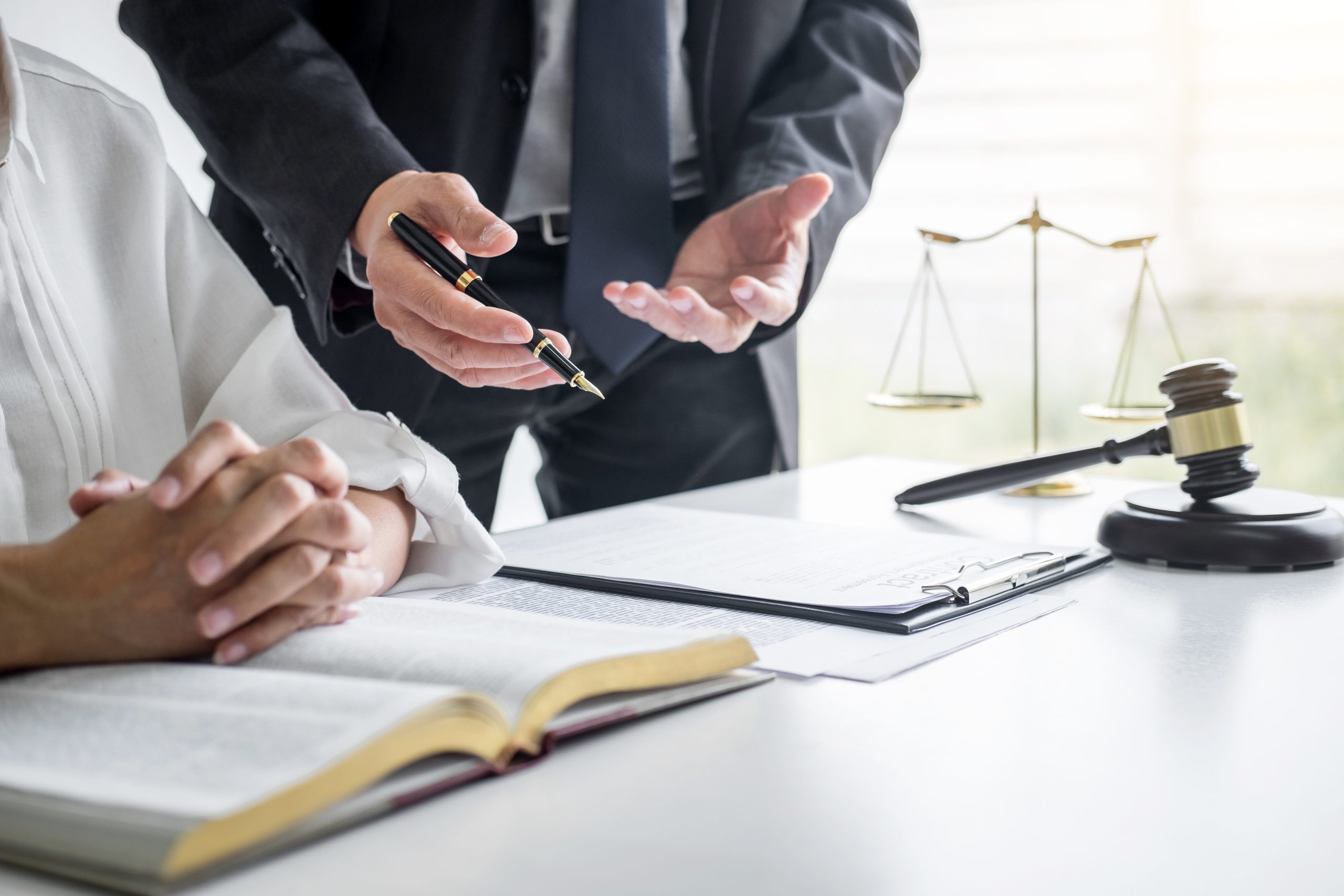 Fire investigation expert consulting with a client while reviewing forensic evidence and legal documentation for a fire-related case.